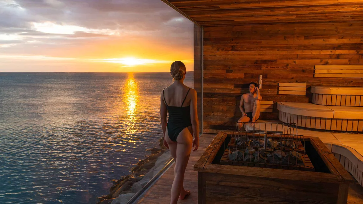Steam drifting over a geothermal bathing lagoon in Iceland on a three-day wellness trip that includes Laugarás Lagoon